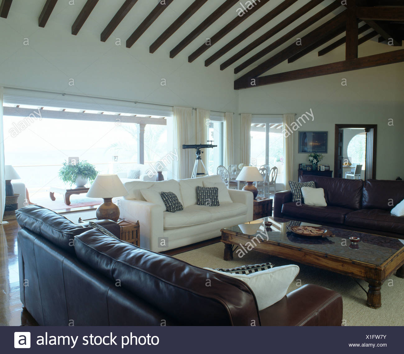 Brown Leather Sofas And White Sofa In Modern Coastal Living Room in size 1300 X 1141
