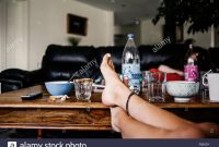 Low Section Of Woman With Feet Up On Coffee Table At Home Stock regarding sizing 1300 X 956